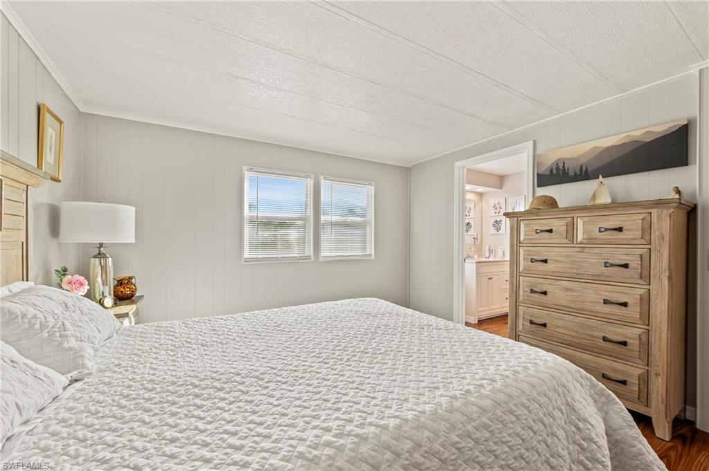 284 Cape Sable Drive Naples, FL 34104 - Photo 12 of 20 a bedroom with a bed and a window
