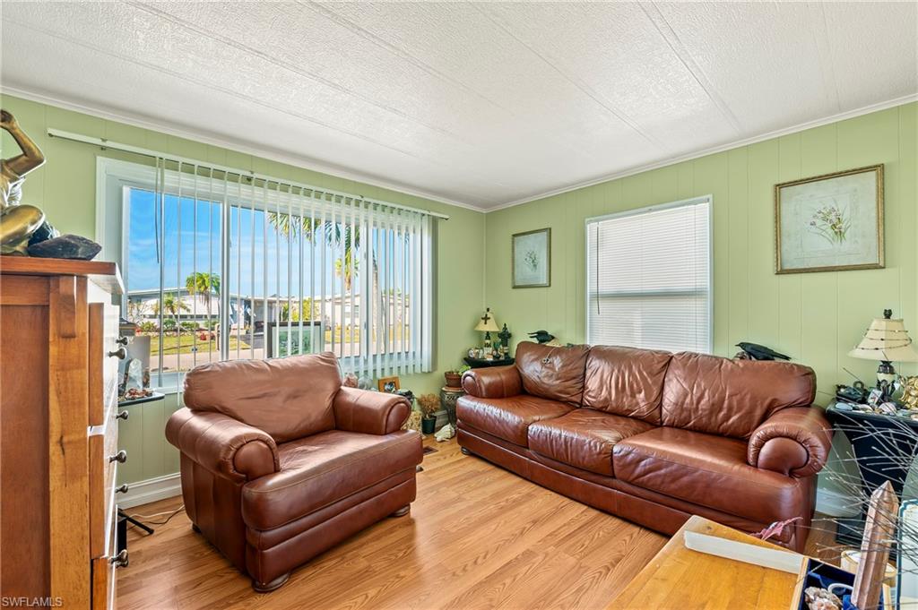 284 Cape Sable Drive Naples, FL 34104 - Photo 13 of 20 a living room with furniture and a large window