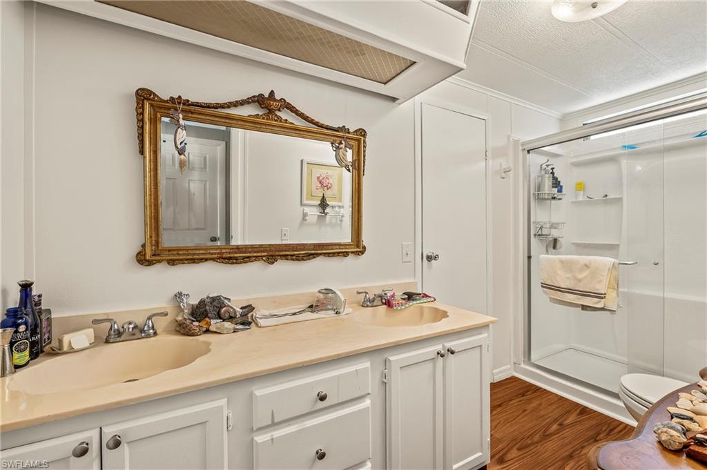 284 Cape Sable Drive Naples, FL 34104 - Photo 14 of 20 a bathroom with a sink and a mirror