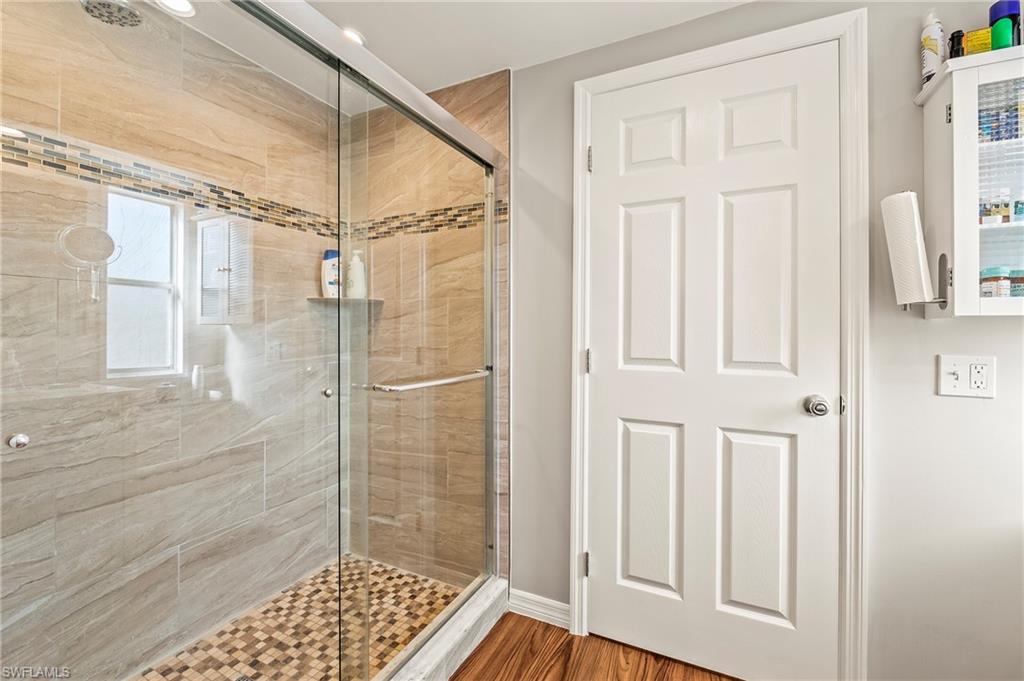 284 Cape Sable Drive Naples, FL 34104 - Photo 15 of 20 a bathroom with a glass door shower