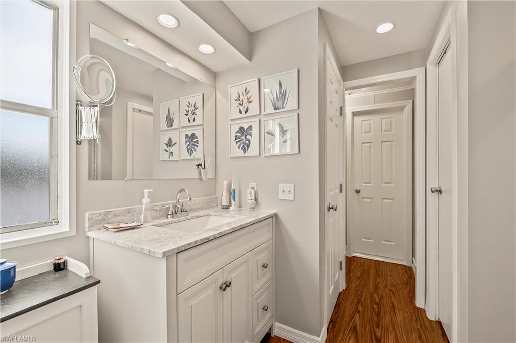 284 Cape Sable Drive Naples, FL 34104 - Photo 16 of 20 a bathroom with a sink a mirror and a shower