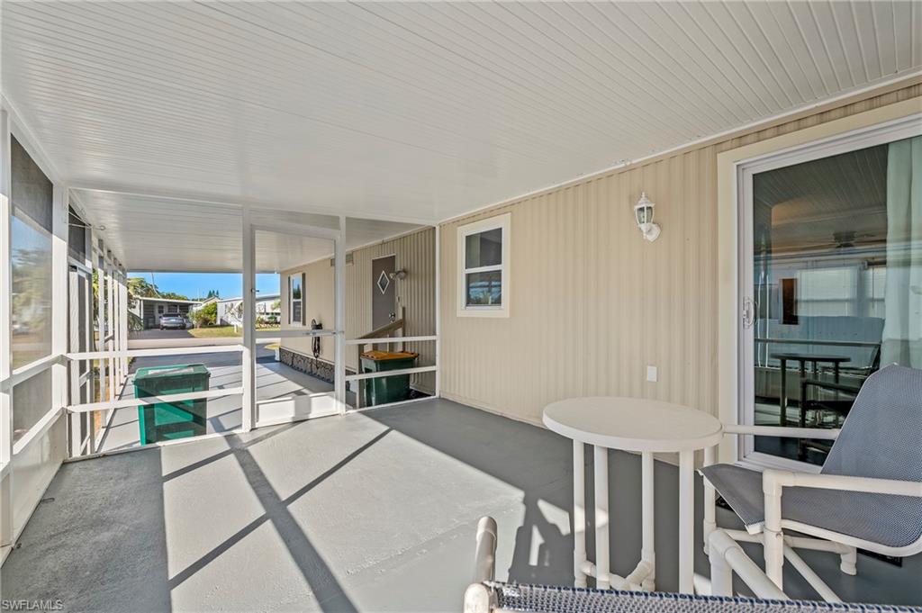 284 Cape Sable Drive Naples, FL 34104 - Photo 19 of 20 a kitchen with white cabinets and stainless steel appliances