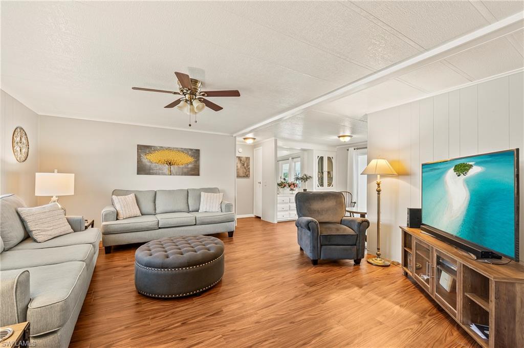 284 Cape Sable Drive Naples, FL 34104 - Photo 3 of 20 a living room with furniture and a flat screen tv