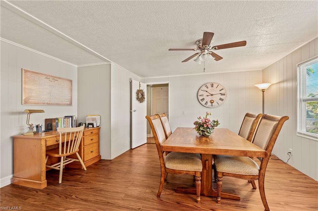 284 Cape Sable Drive Naples, FL 34104 - Photo 5 of 20 a view of a dining room with furniture and wooden floor