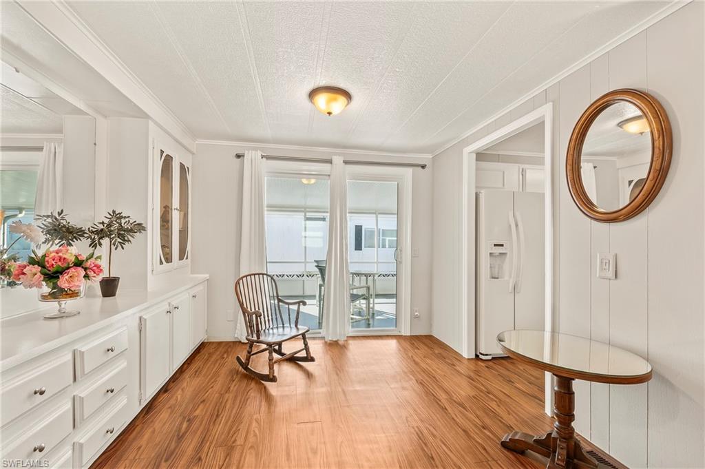284 Cape Sable Drive Naples, FL 34104 - Photo 6 of 20 a view of a room with wooden floor and furniture