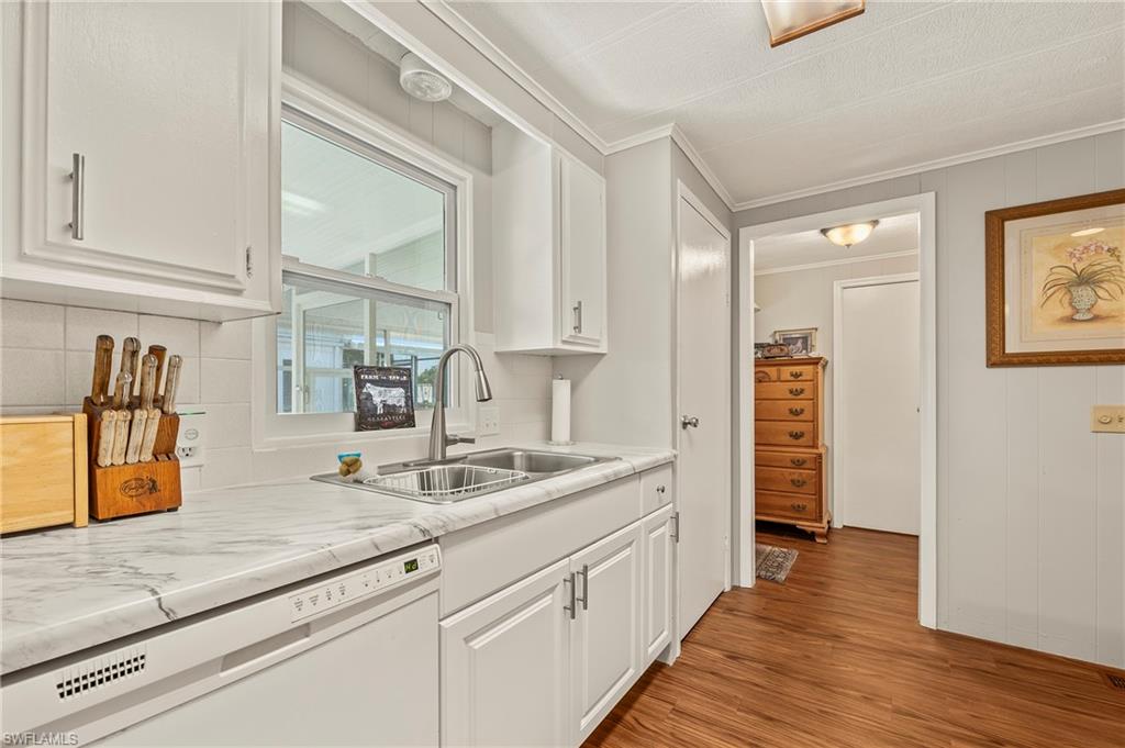 284 Cape Sable Drive Naples, FL 34104 - Photo 7 of 20 a hallway with sink and mirror