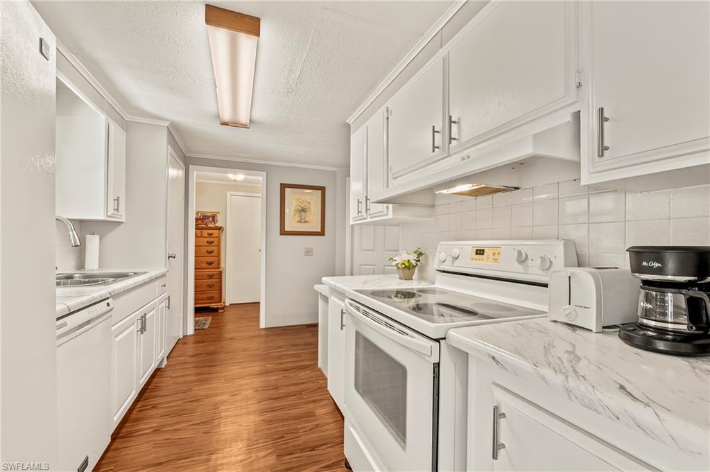 284 Cape Sable Drive Naples, FL 34104 - Photo 9 of 20 a kitchen with a stove oven and sink