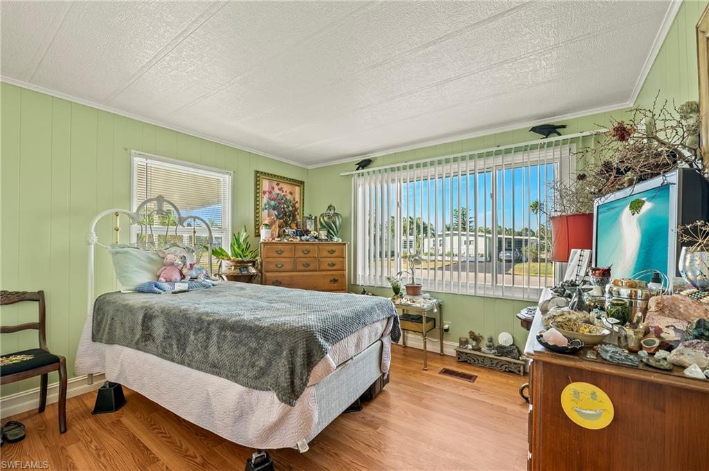 284 Cape Sable Drive Naples, FL 34104 - Photo 10 of 20 a bedroom with a bed and large windows