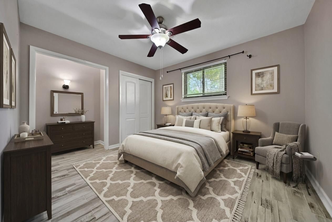 2006 Mermaid Lane Houston, TX 77062 - Photo 21 of 35 a bedroom with a bed and a chandelier