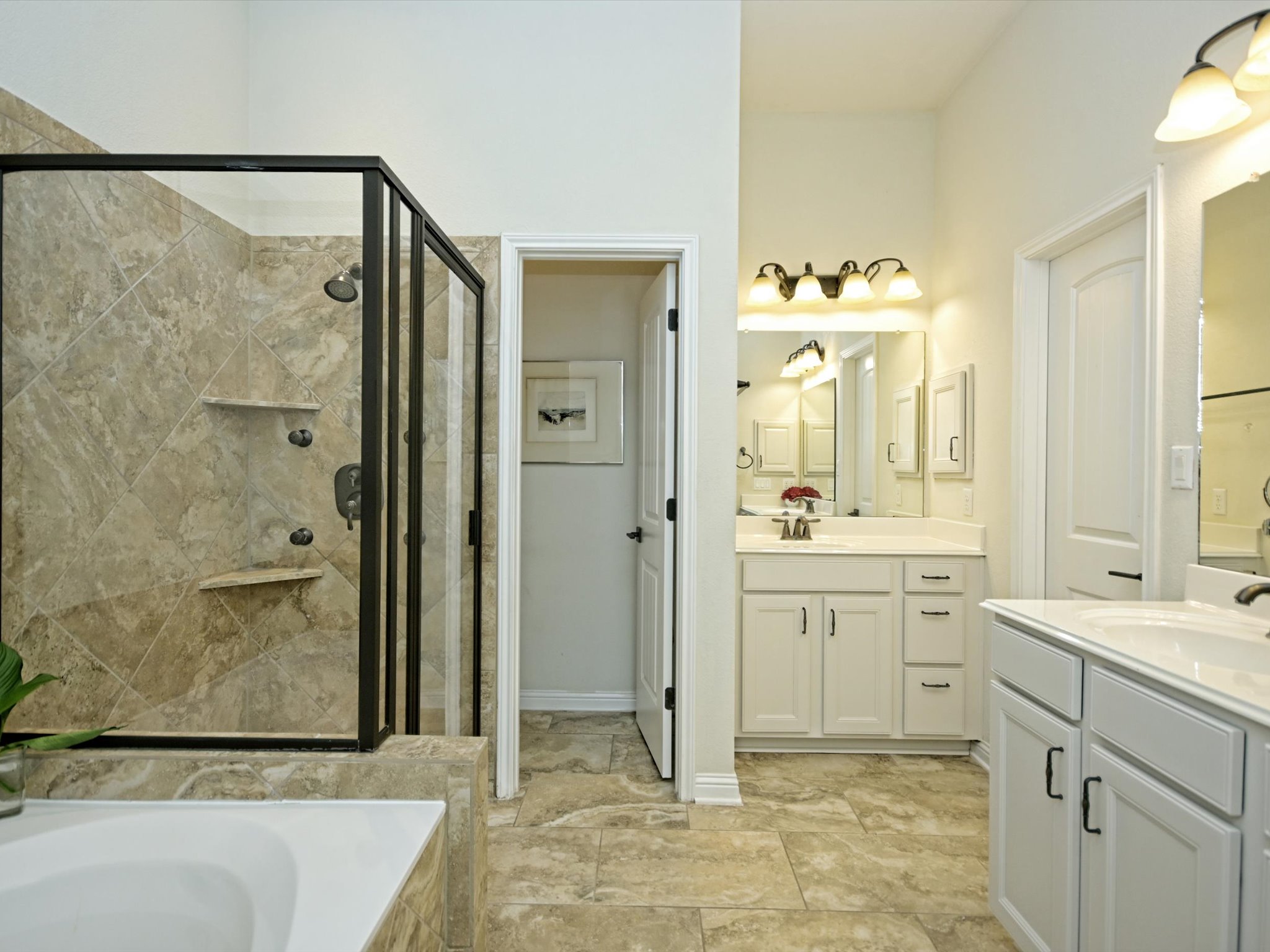 201 Bellagio Drive Austin, TX 78734 - Photo 15 of 31 Enjoy your own private ensuite bath complete with two separate vanities, a walk-in closet, and private toilet.