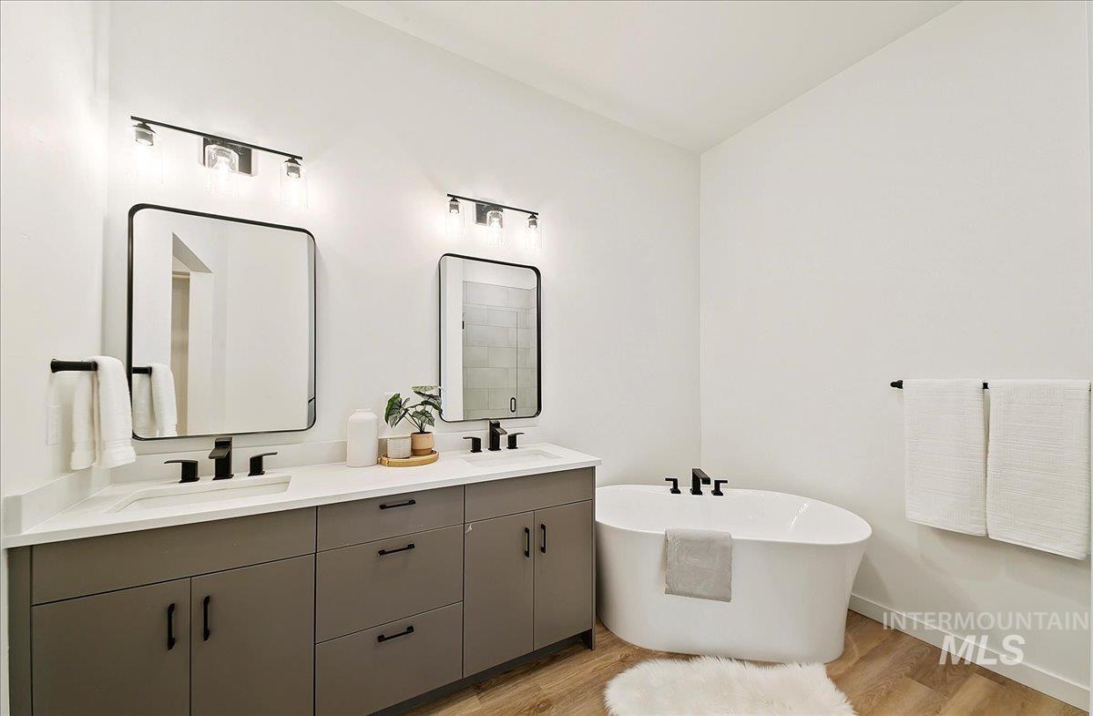 2044 South Mackinnon Lane Boise, ID 83706 - Photo 27 of 48 Full bath featuring light wood-type flooring, a freestanding bath, and double vanity