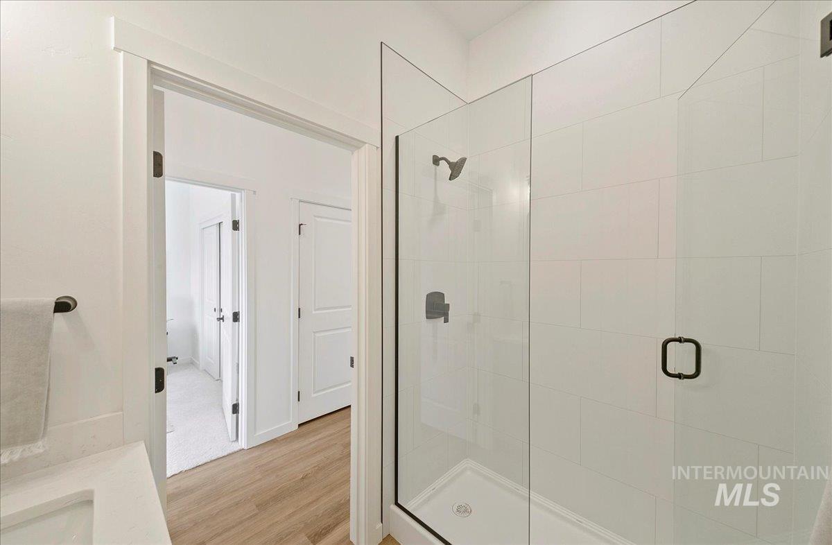 2044 South Mackinnon Lane Boise, ID 83706 - Photo 35 of 48 Bathroom featuring a stall shower, light wood finished floors, and vanity