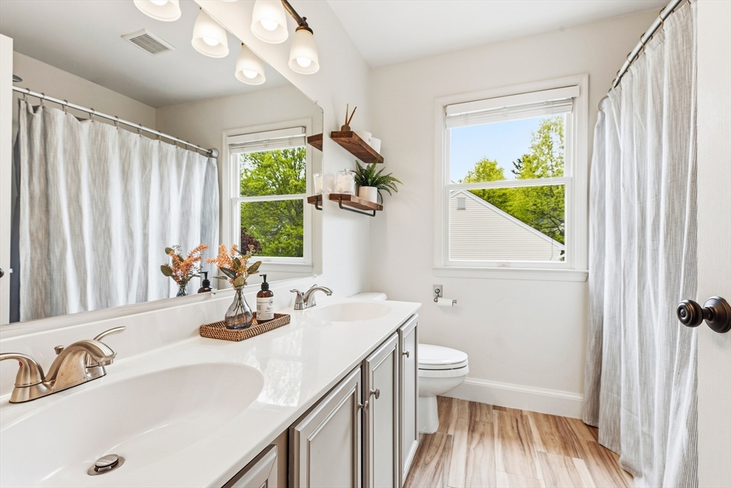 6 Hancock Road Franklin, MA 02038 - Photo 26 of 32 a bathroom with a sink a toilet and a mirror