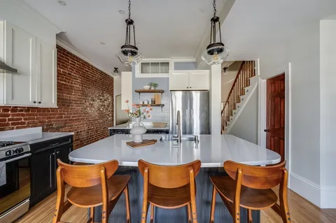 a dining room with furniture and wooden floor