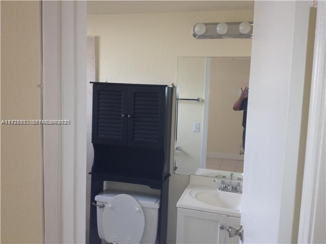 241 Southeast 9th Avenue, Unit 106 Pompano Beach, FL 33060 - Photo 10 of 19 a bathroom with a toilet and a sink