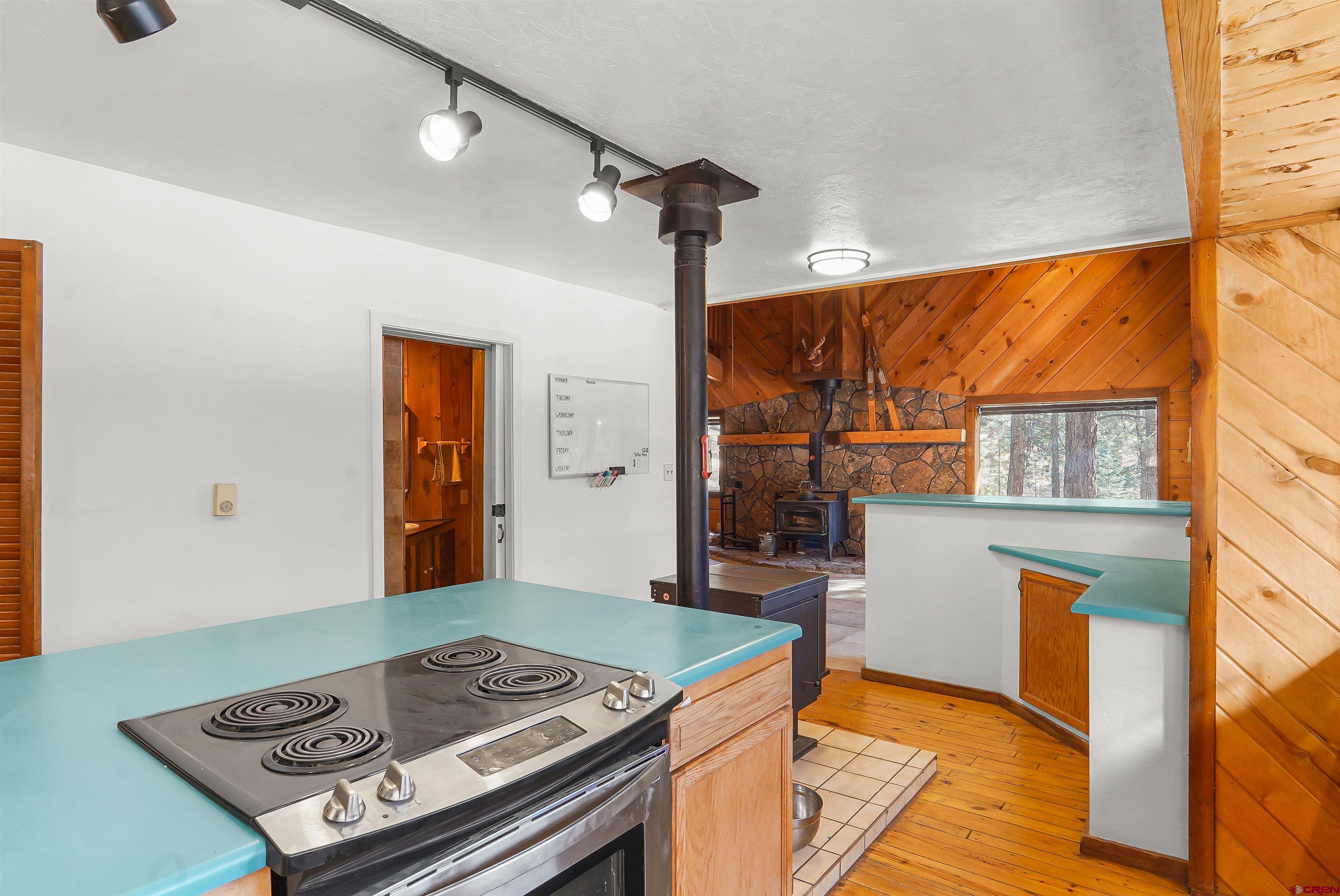 78 Groves Drive Durango, CO 81301 - Photo 12 of 35 a kitchen with a stove and a wooden floor