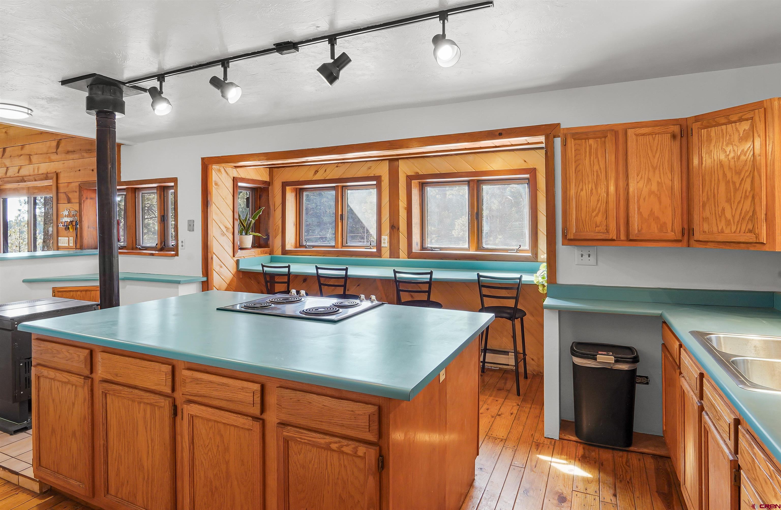78 Groves Drive Durango, CO 81301 - Photo 13 of 35 a kitchen with stainless steel appliances granite countertop a sink a stove and a wooden floors