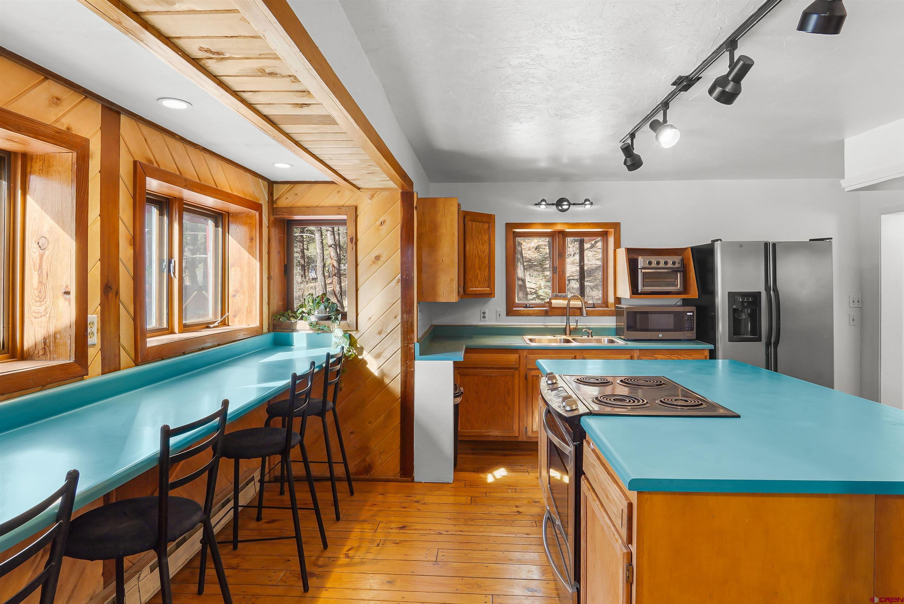 78 Groves Drive Durango, CO 81301 - Photo 9 of 35 a kitchen with stainless steel appliances granite countertop sink stove and table