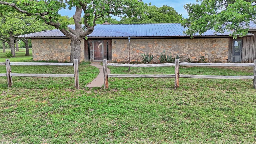 3377 Lodge Creek Road Henrietta, TX 76365 - Photo 21 of 40 a view of a house with backyard and a tree