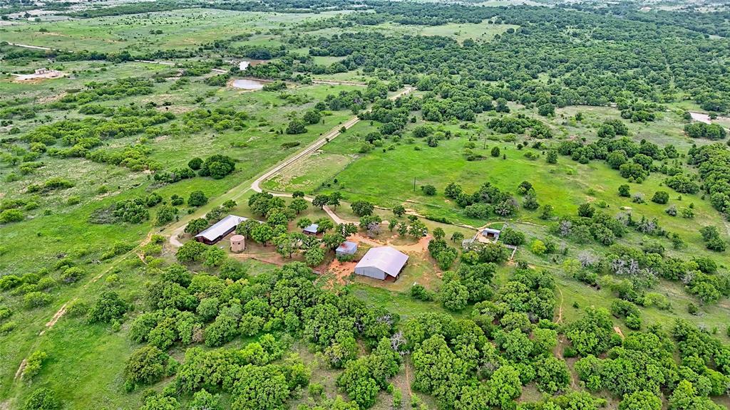 3377 Lodge Creek Road Henrietta, TX 76365 - Photo 3 of 40 a backyard of a house with lots of green space and forest view