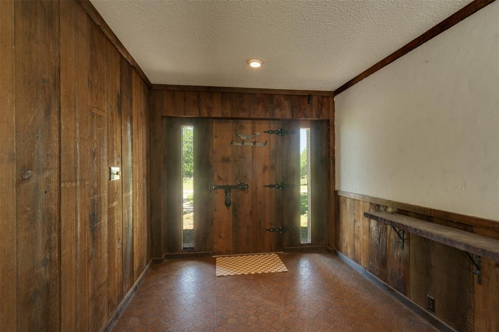 3377 Lodge Creek Road Henrietta, TX 76365 - Photo 7 of 40 a view of entryway with wooden walls