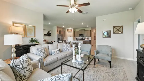 a living room with furniture and a lamp
