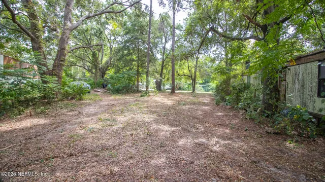an aerial view of a house with a yard and garden