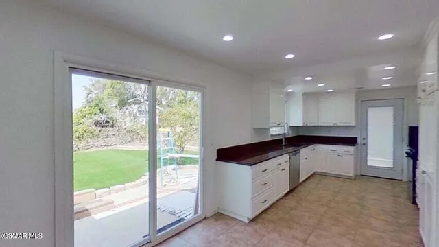 a kitchen with a sink and large window
