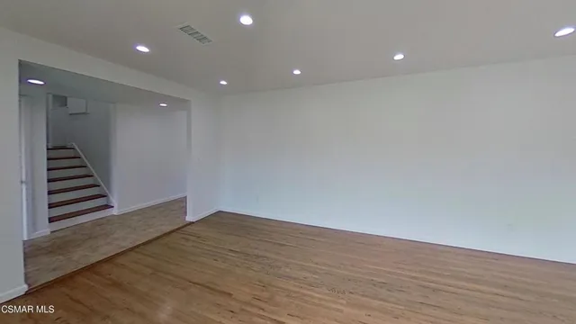 a view of wooden floor and staircase in a room
