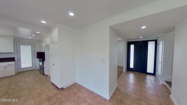 a view of a hallway with seating space