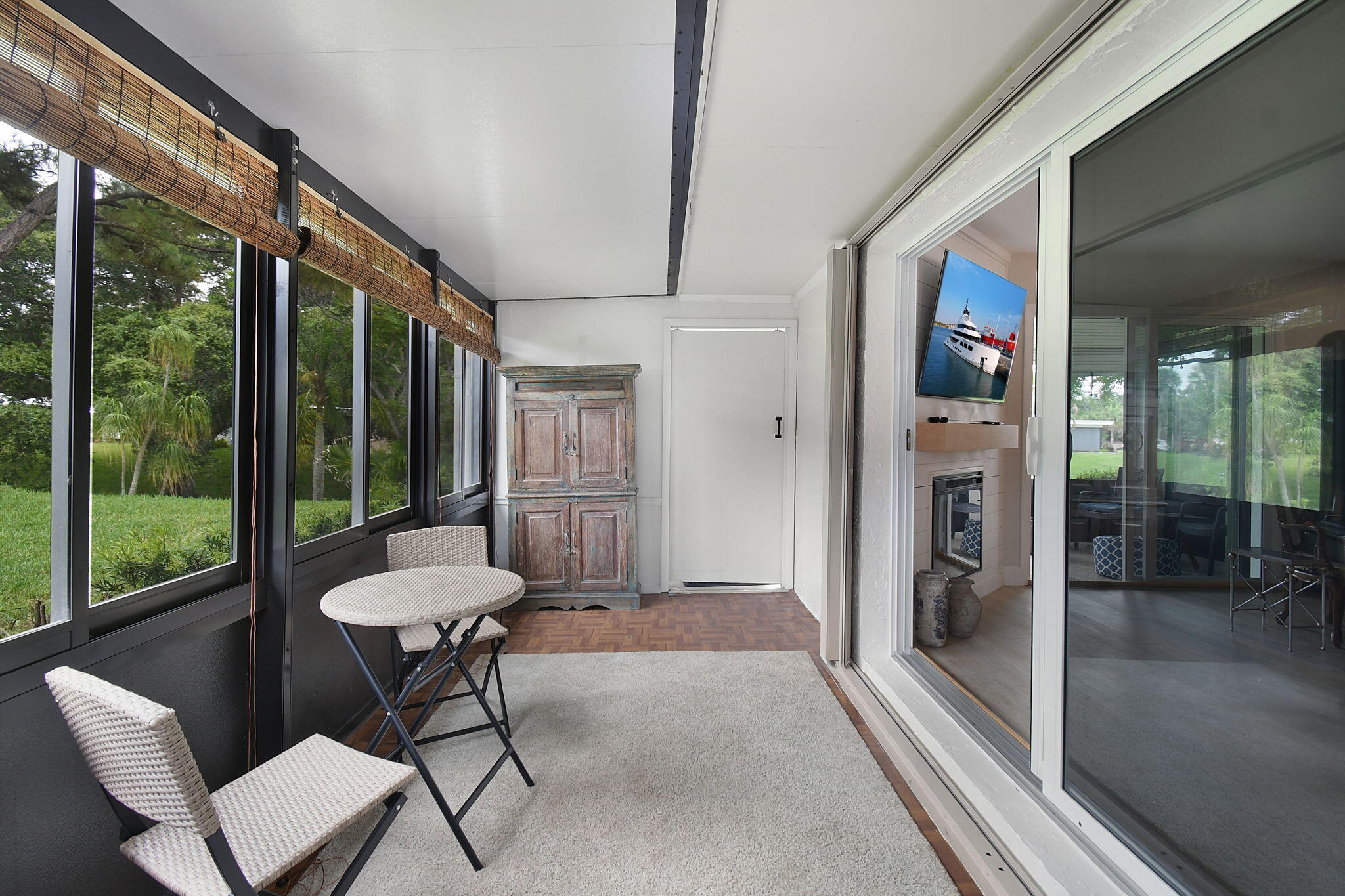5251 Southeast Sea Island Way Stuart, FL 34997 - Photo 27 of 68 a living room with furniture and a floor to ceiling window