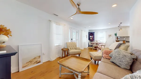 a living room with furniture and kitchen view