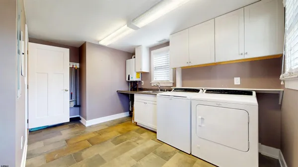 a kitchen with granite countertop kitchen island stainless steel appliances a refrigerator a sink and a stove