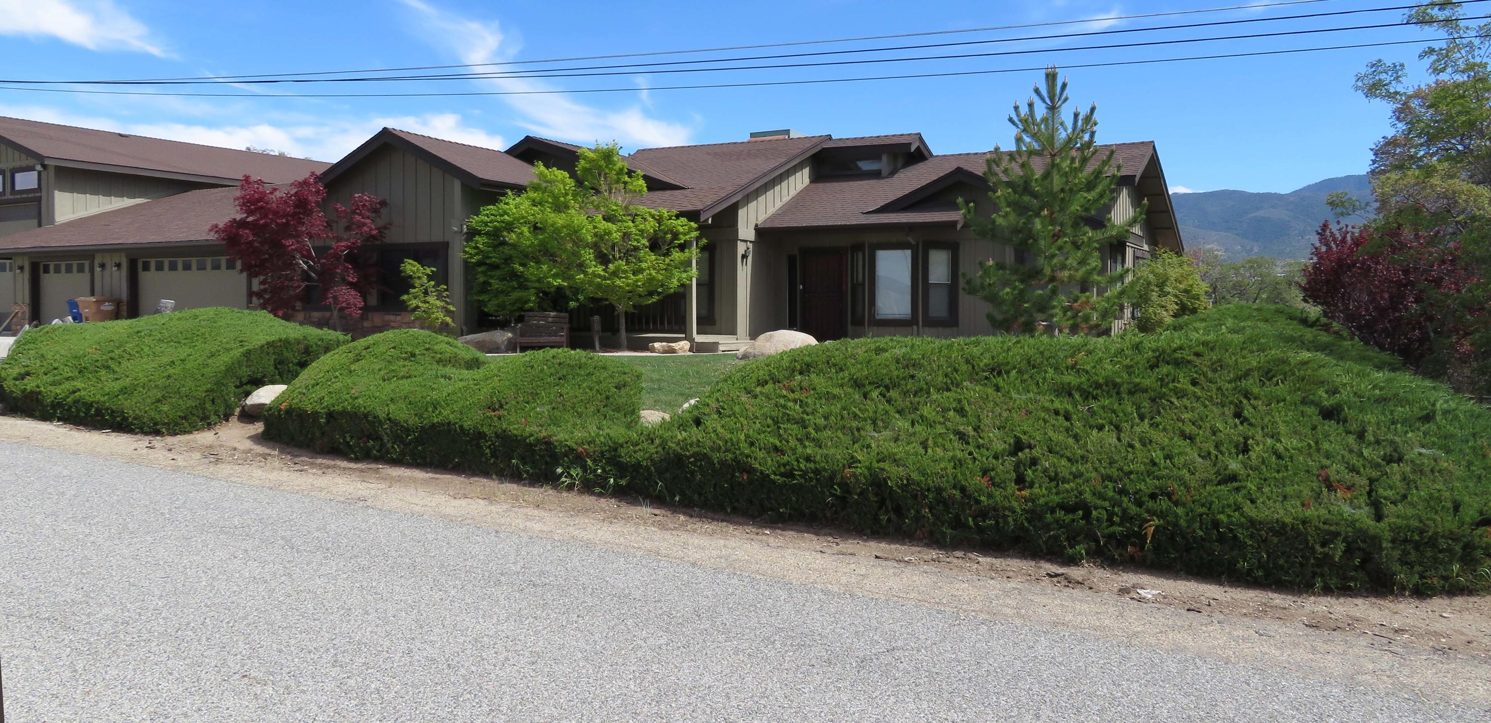21175 Ridgeway Drive Tehachapi, CA 93561 - Photo 1 of 45 a front view of a house with a yard and garage
