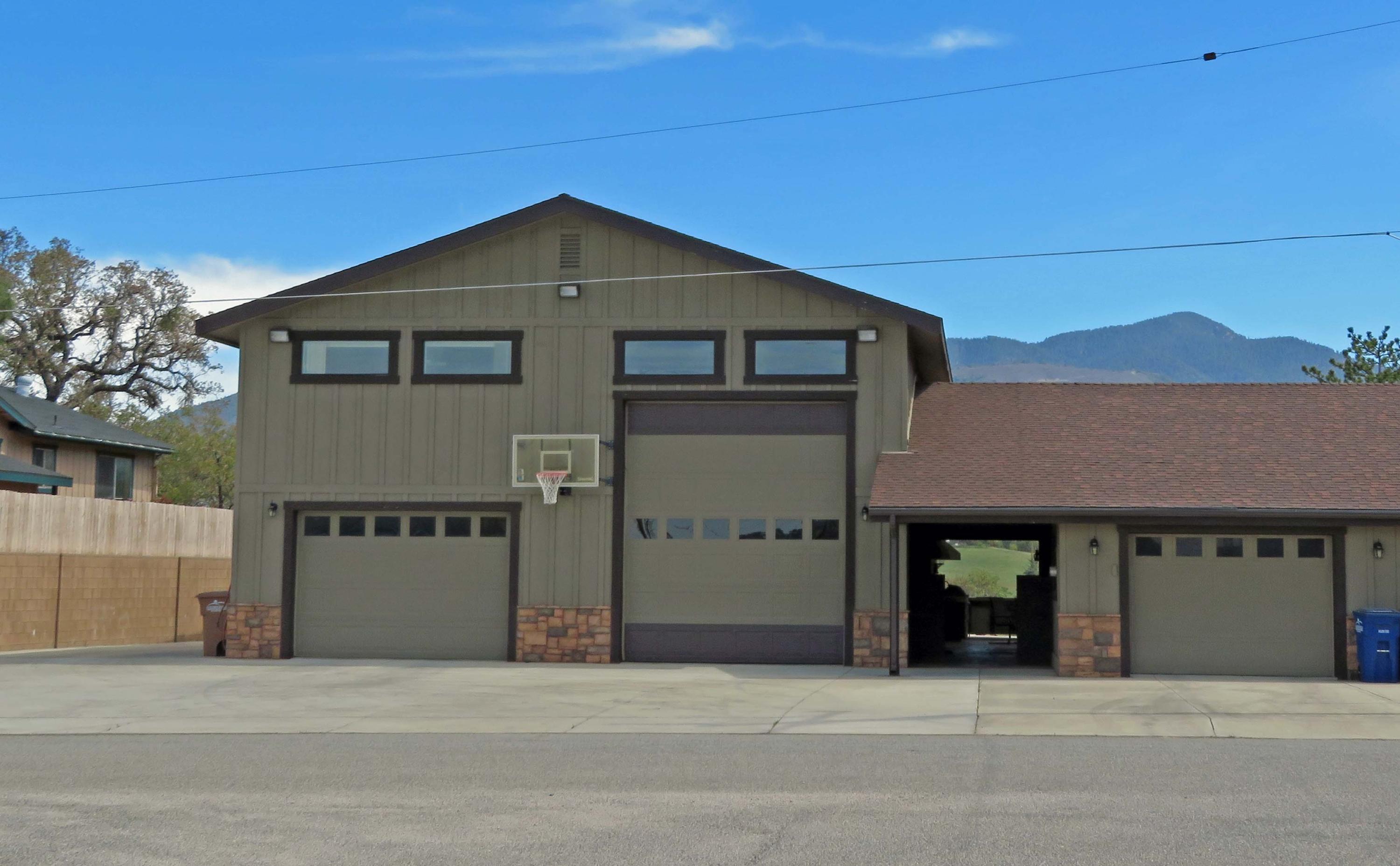 21175 Ridgeway Drive Tehachapi, CA 93561 - Photo 2 of 45 a front view of a house with a yard and garage