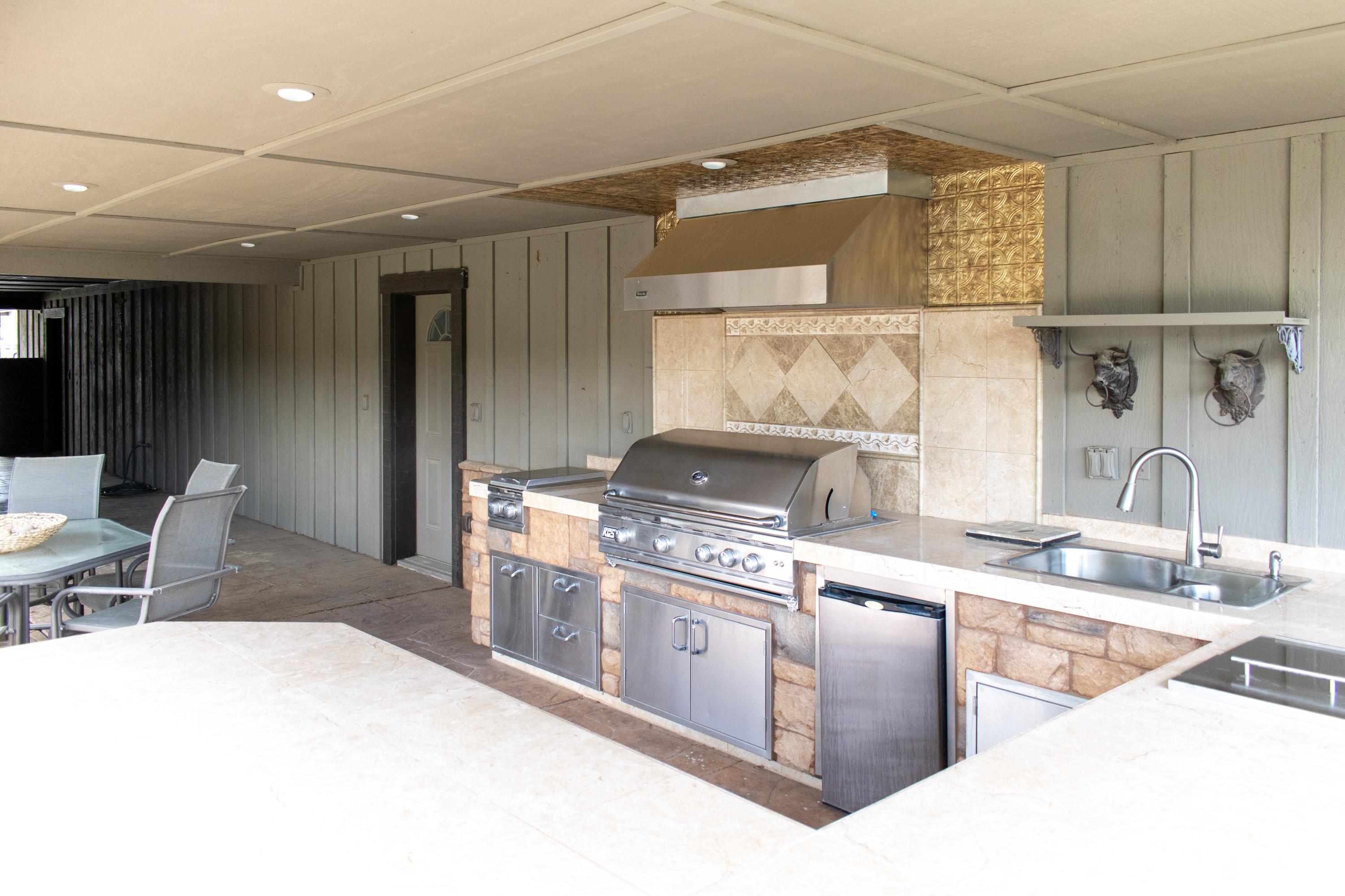 21175 Ridgeway Drive Tehachapi, CA 93561 - Photo 13 of 45 a kitchen with stainless steel appliances granite countertop a sink and a stove