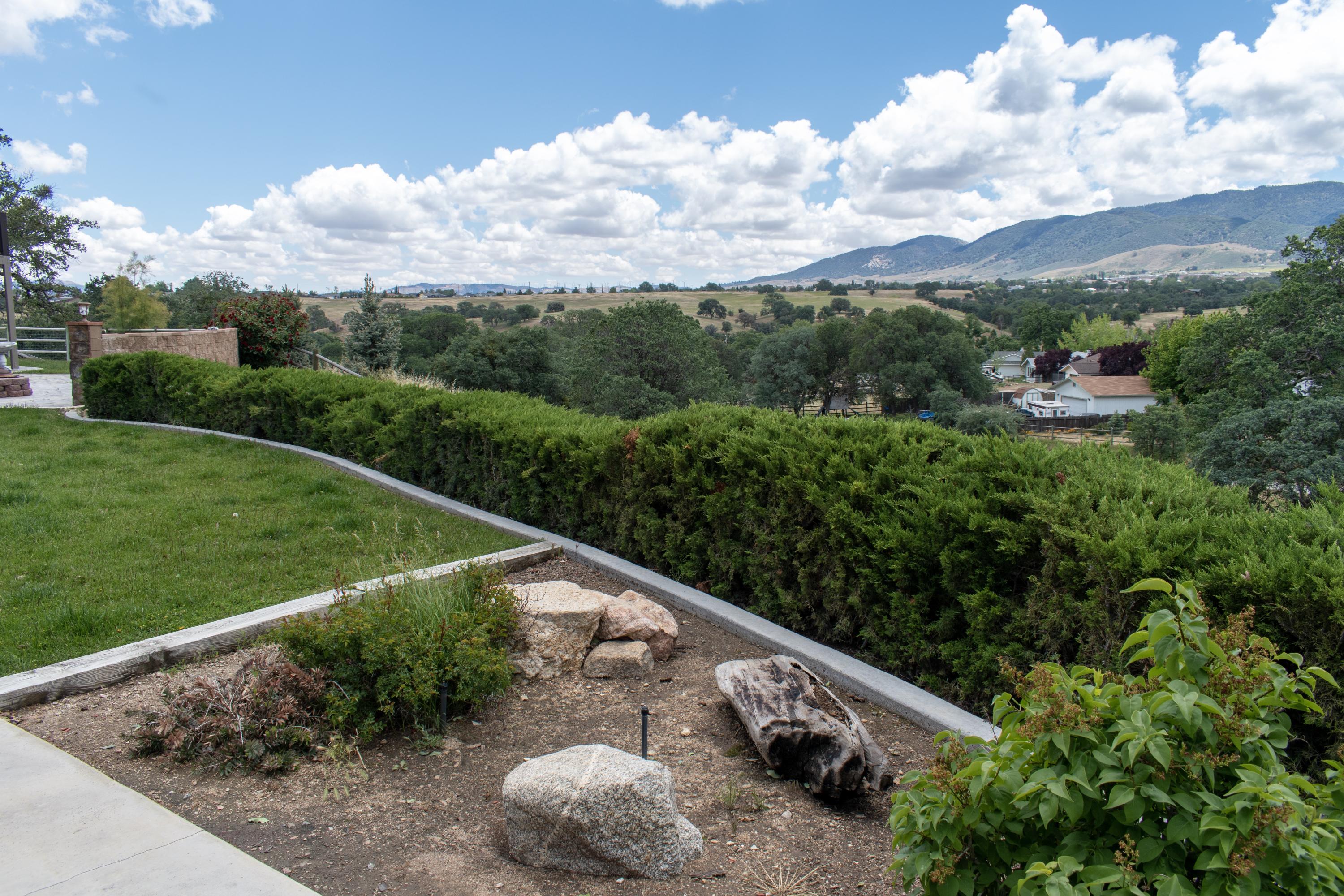 21175 Ridgeway Drive Tehachapi, CA 93561 - Photo 16 of 45 a view of a yard with table and chairs