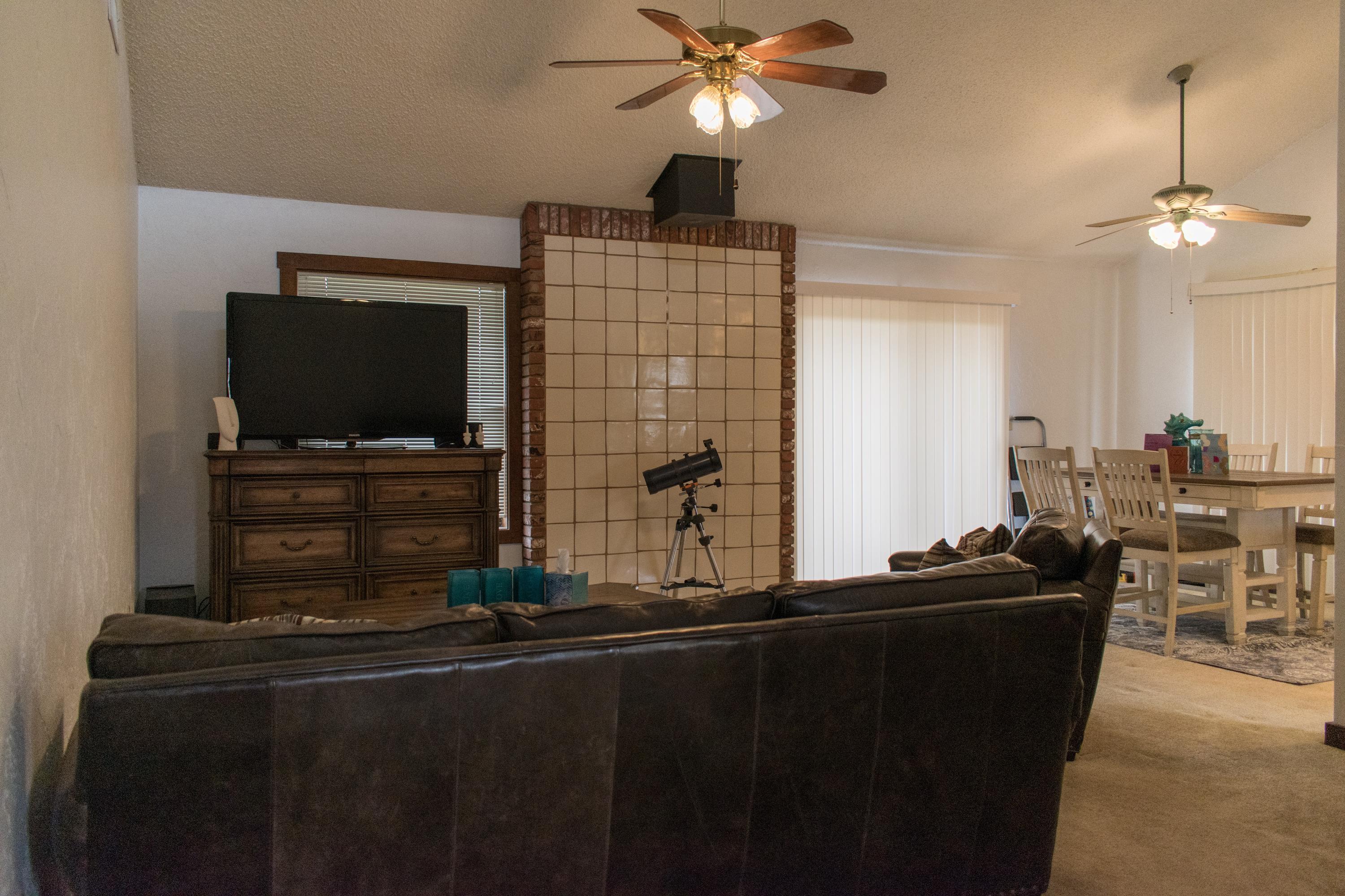 21175 Ridgeway Drive Tehachapi, CA 93561 - Photo 22 of 45 a room with table chairs and flat screen tv