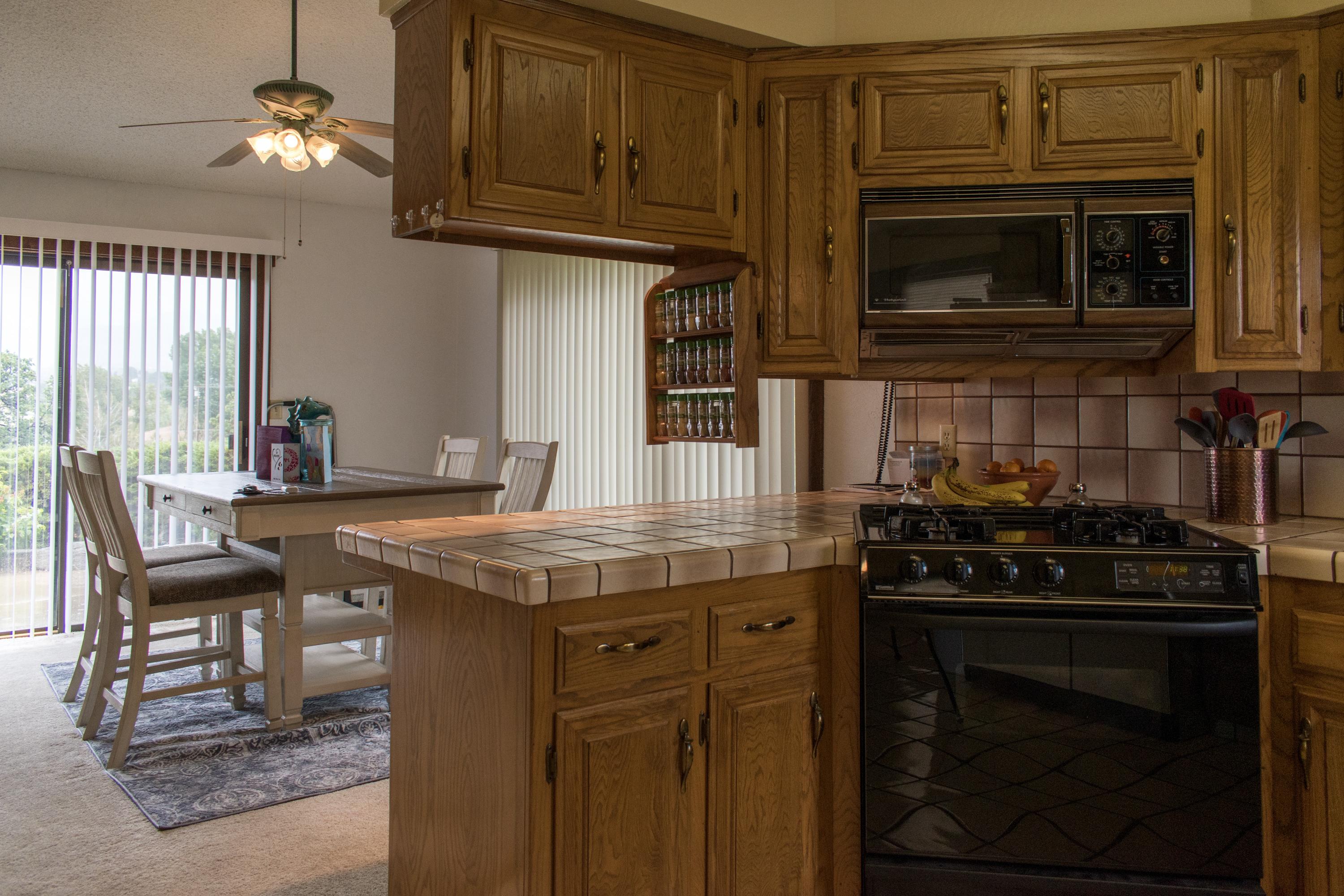 21175 Ridgeway Drive Tehachapi, CA 93561 - Photo 23 of 45 a kitchen with a stove and a microwave