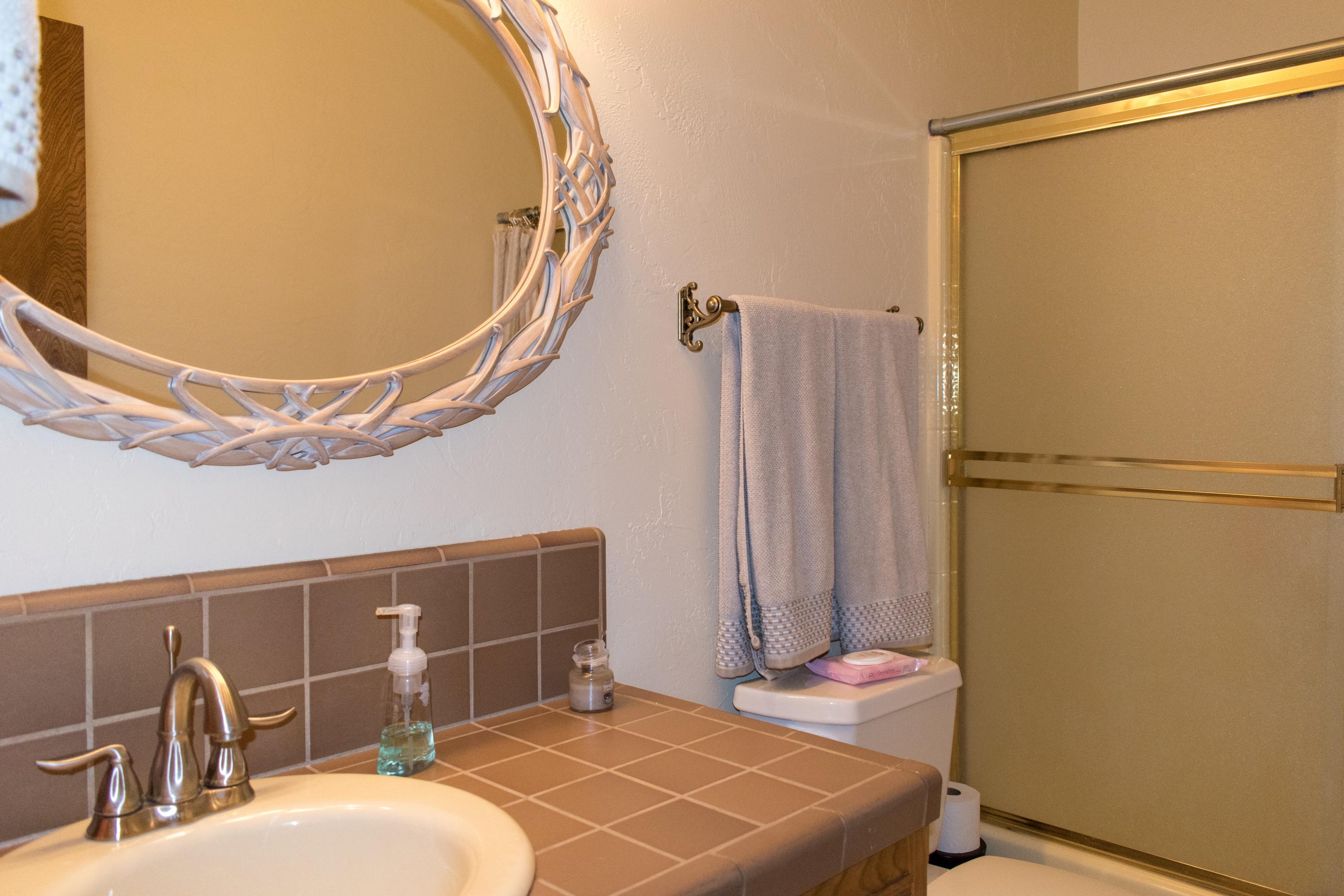 21175 Ridgeway Drive Tehachapi, CA 93561 - Photo 30 of 45 a bathroom with a sink and a mirror