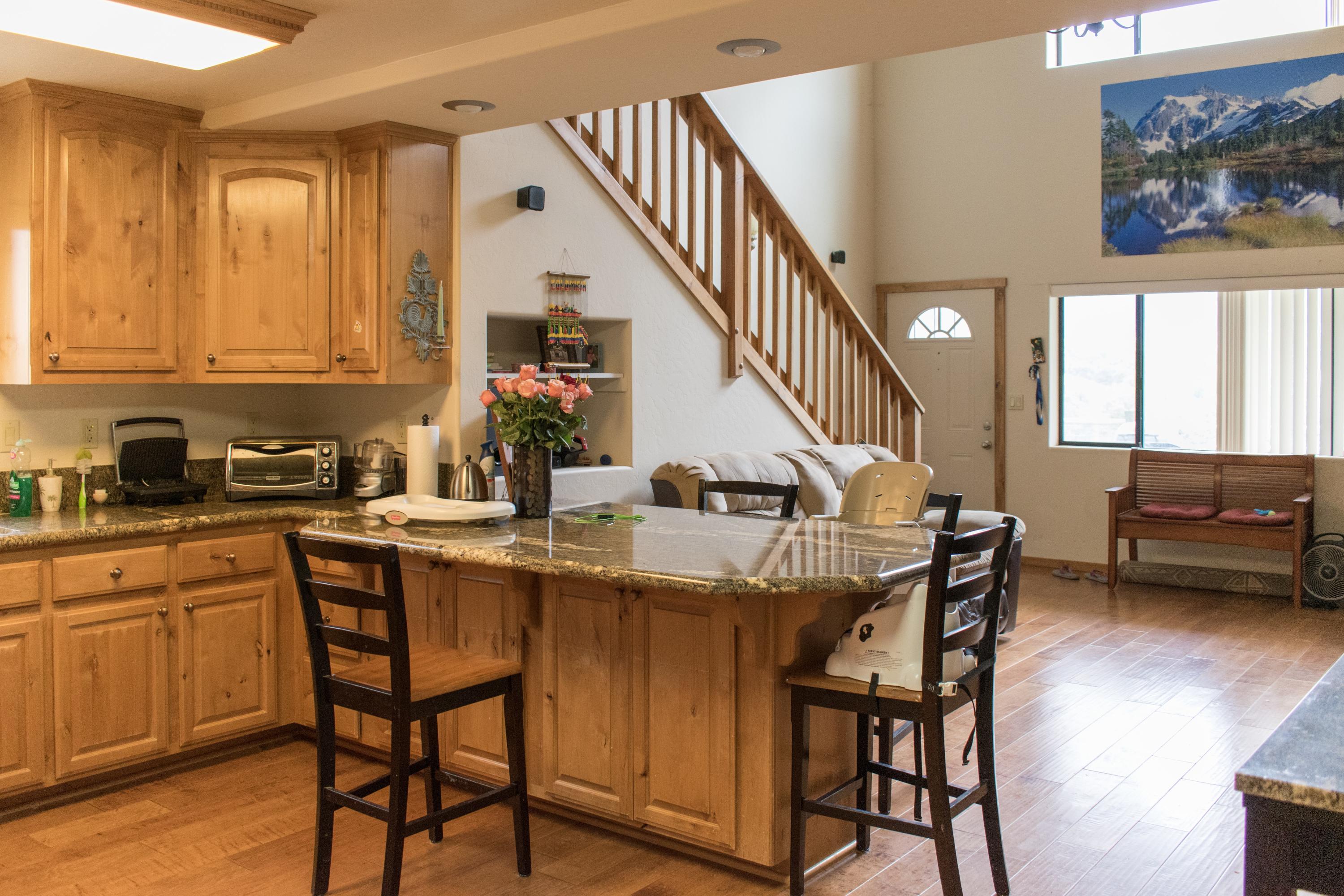 21175 Ridgeway Drive Tehachapi, CA 93561 - Photo 39 of 45 a kitchen with a table chairs sink and cabinets