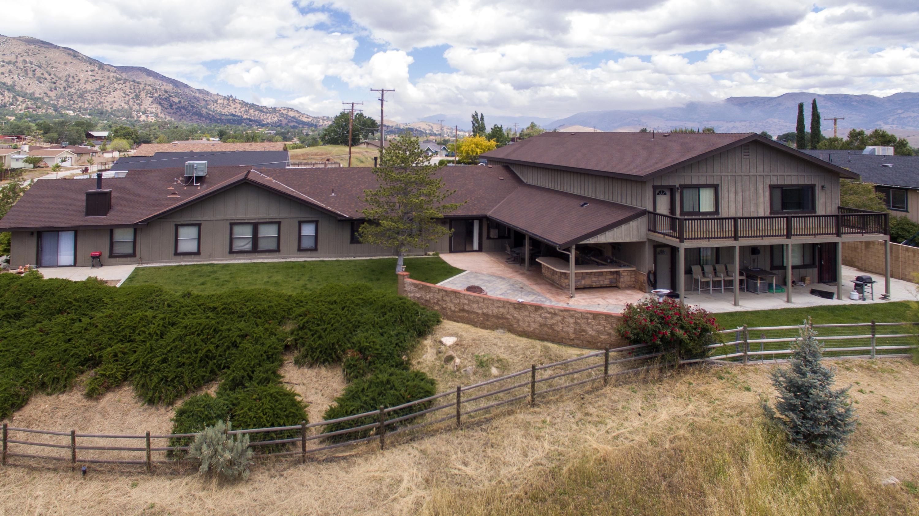 21175 Ridgeway Drive Tehachapi, CA 93561 - Photo 6 of 45 a front view of a house with a yard
