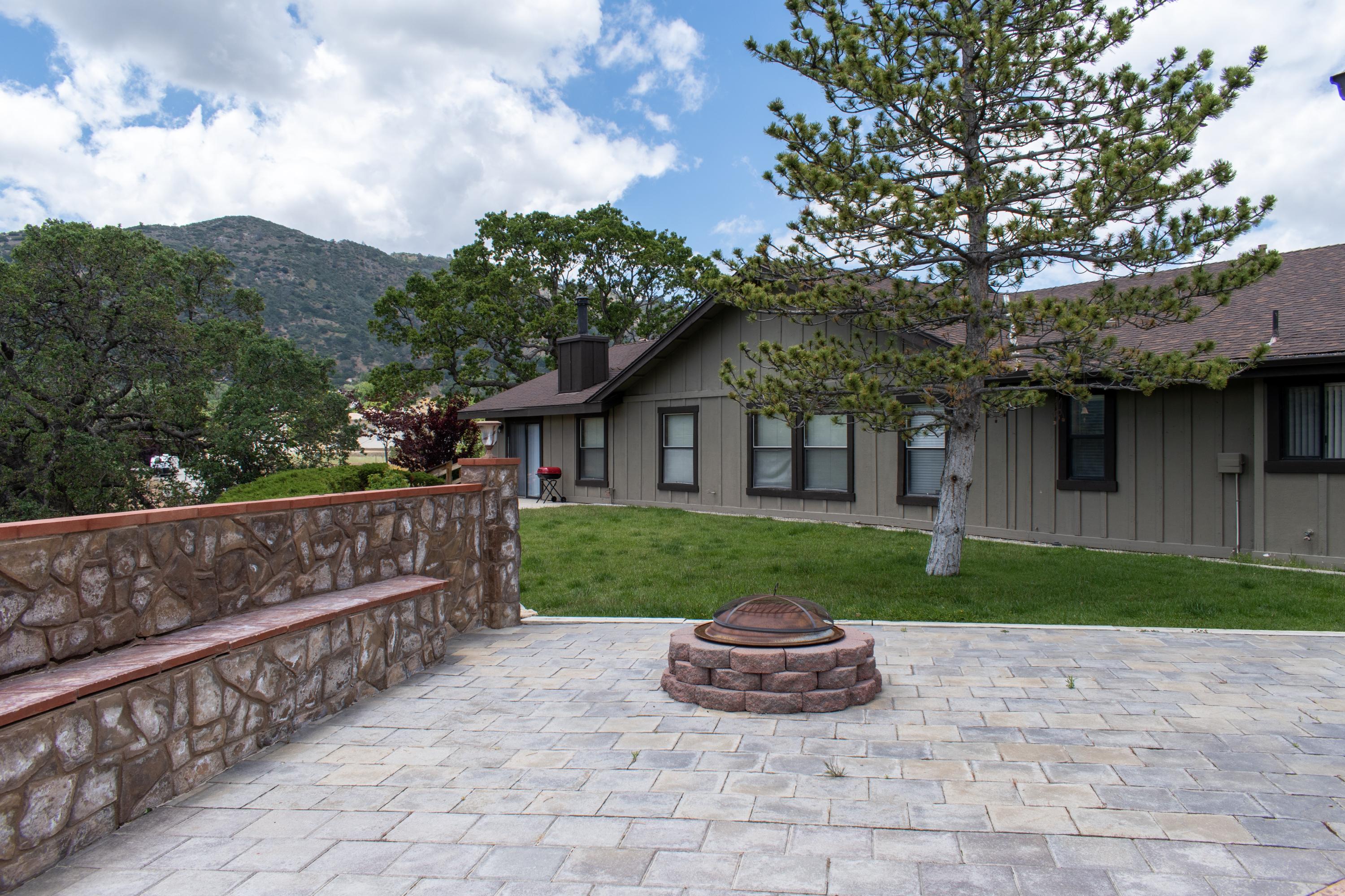 21175 Ridgeway Drive Tehachapi, CA 93561 - Photo 10 of 45 a view of a house with a yard and pathway