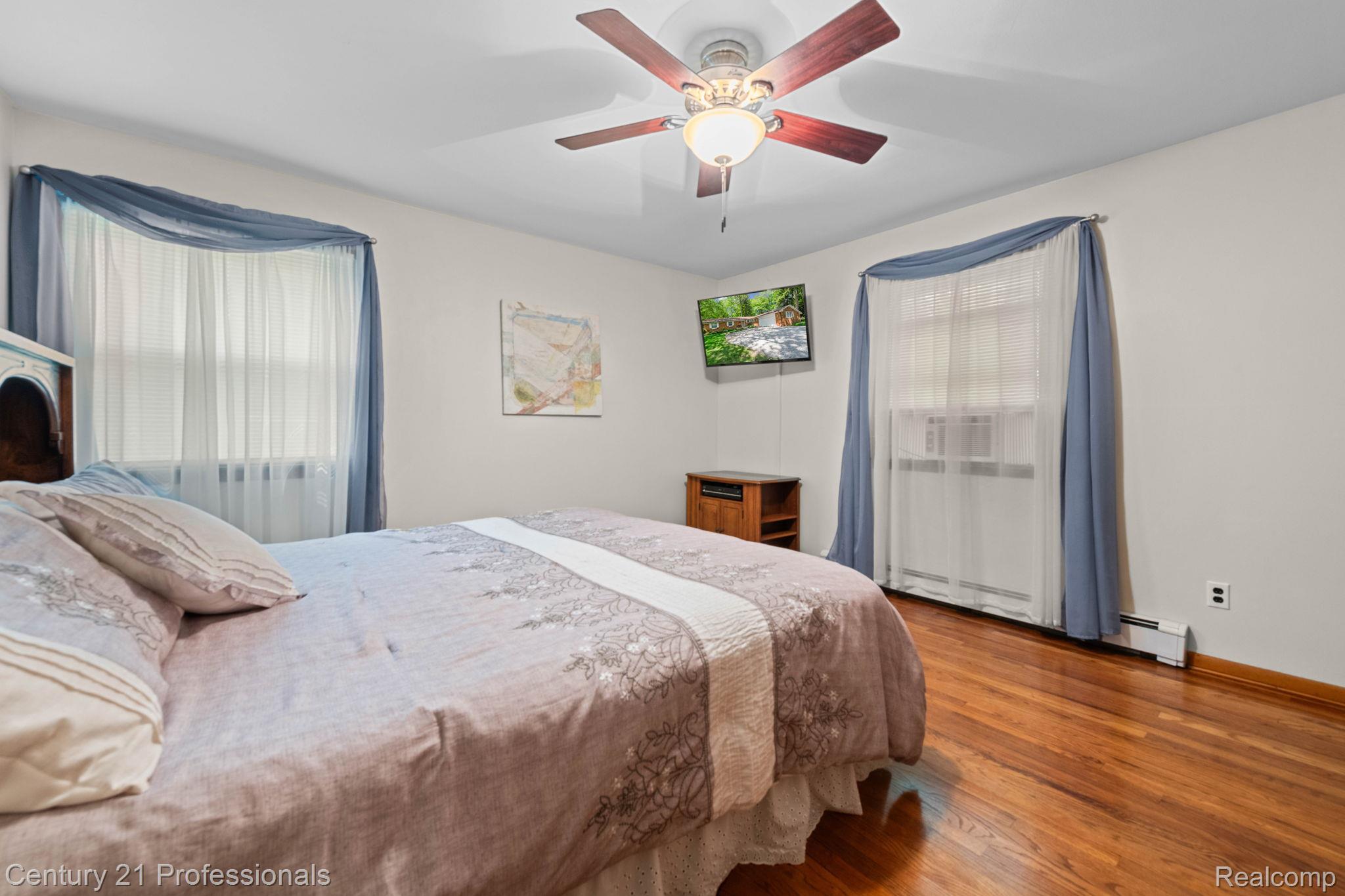 8638 Stone Road Algonac, MI 48001 - Photo 24 of 70 Bedroom with wood finished floors and ceiling fan