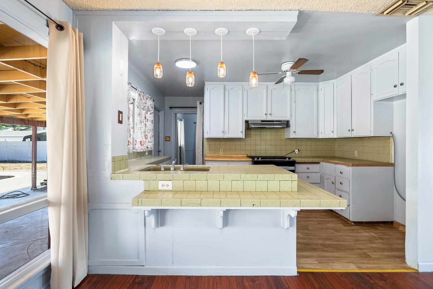 3009 Fowler Avenue Clovis, CA 93611 - Photo 14 of 34 a view of a kitchen with kitchen island and stainless steel appliances