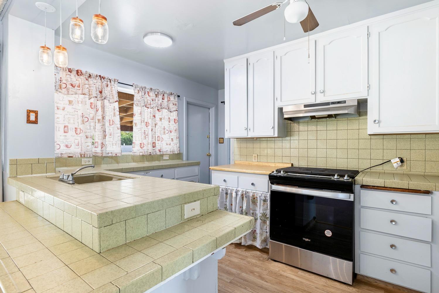 3009 Fowler Avenue Clovis, CA 93611 - Photo 15 of 34 a kitchen with granite countertop a sink a stove and cabinets