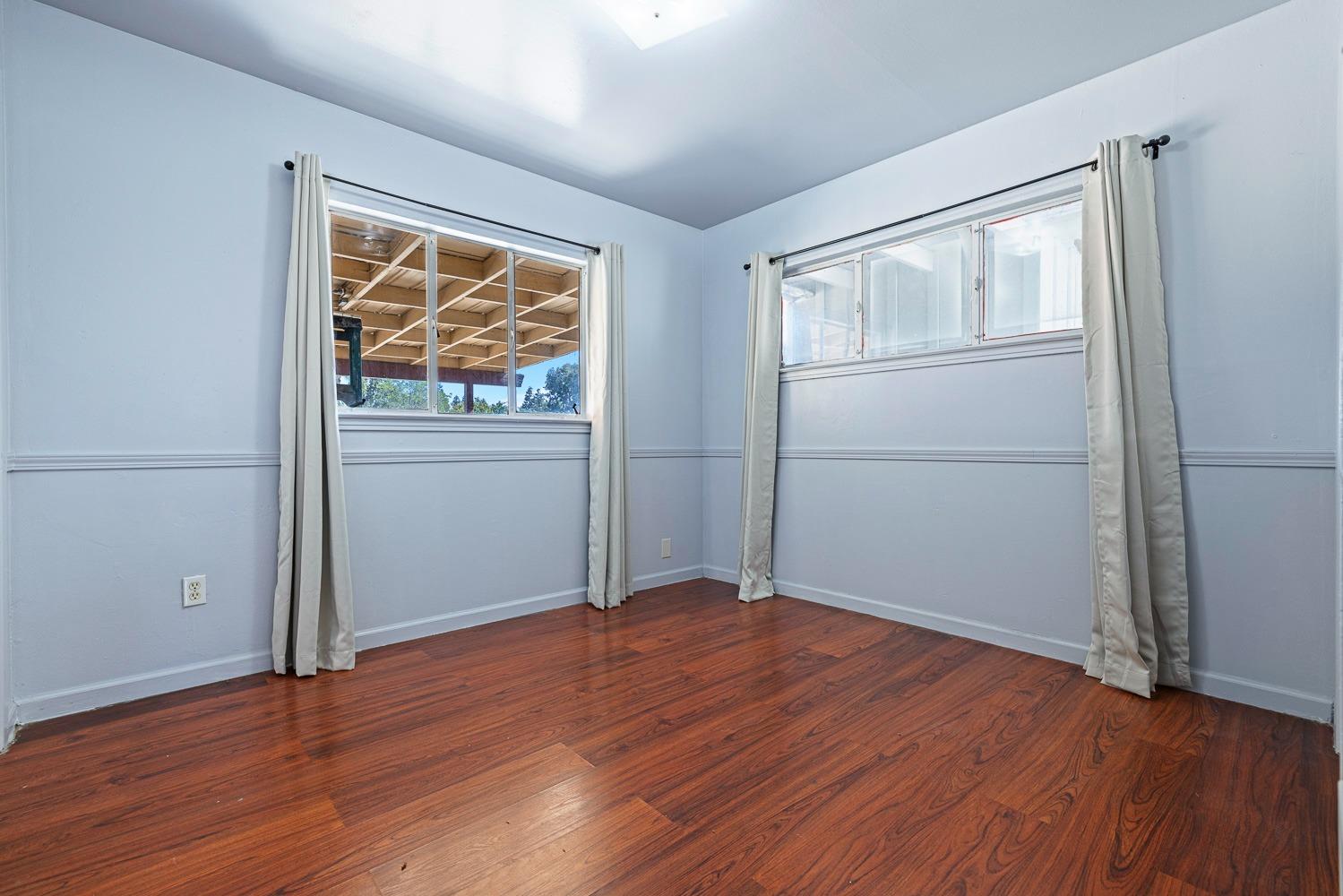 3009 Fowler Avenue Clovis, CA 93611 - Photo 21 of 34 an empty room with wooden floor and windows