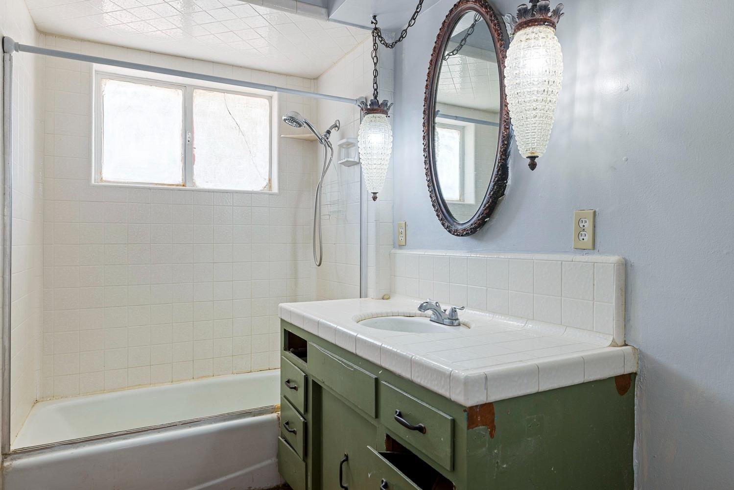 3009 Fowler Avenue Clovis, CA 93611 - Photo 23 of 34 a bathroom with a sink and a mirror
