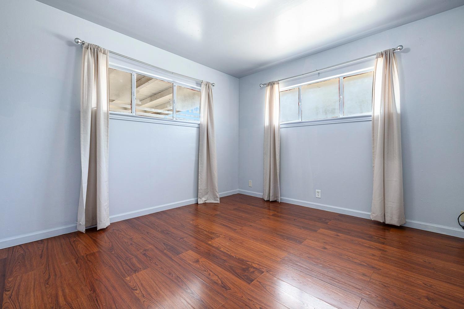 3009 Fowler Avenue Clovis, CA 93611 - Photo 24 of 34 an empty room with wooden floor and windows