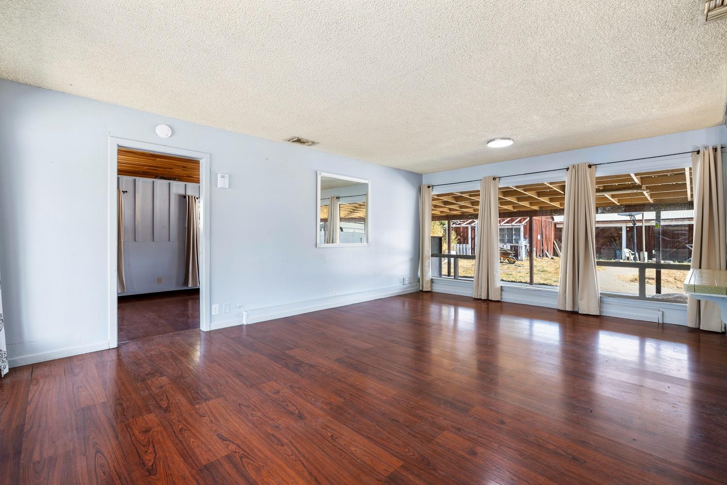 3009 Fowler Avenue Clovis, CA 93611 - Photo 7 of 34 a view of an empty room with window and wooden floor